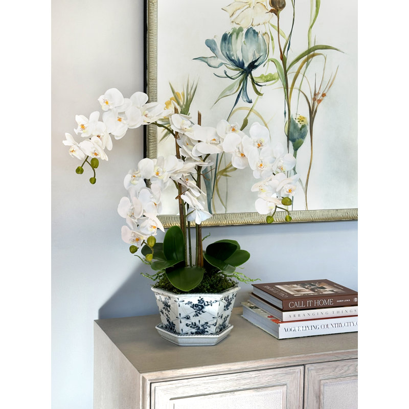 Orchid Floral Arrangement In Decorative Vase With Leaves And Bamboo