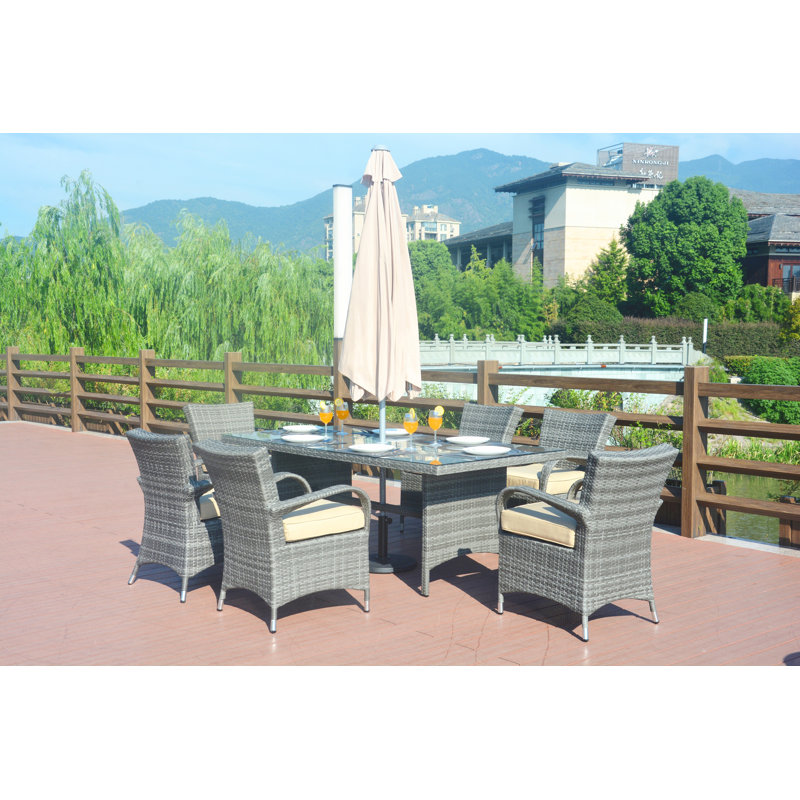 Anntonette 6 - Person Wicker Patio Dining Set with Round Table , Cushions Included, Gray