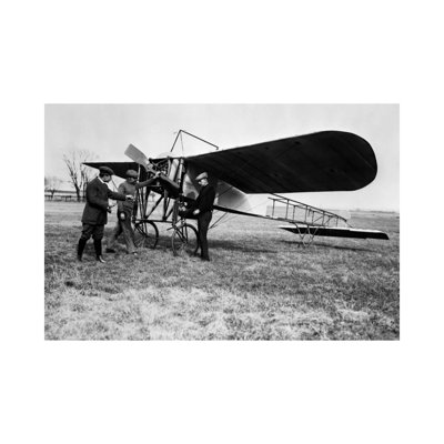 1910S Group Of Three Men Standing In Front Of Early Monoplane One With Hand On Propeller - Wrapped Canvas Print