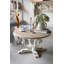 Table basse ronde en bois avec pieds à volutes et finition patinée