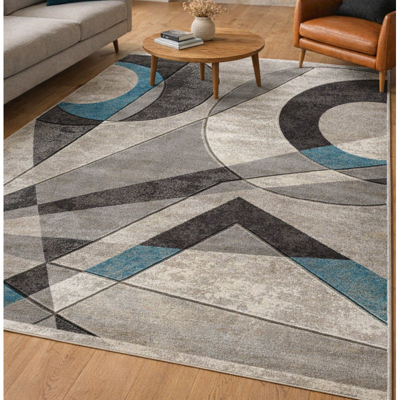 Tapis rectangulaire 9x12 turquoise aux motifs géométriques sculptés à la main, en polyester doux à poils courts, pour salon ou chambre.