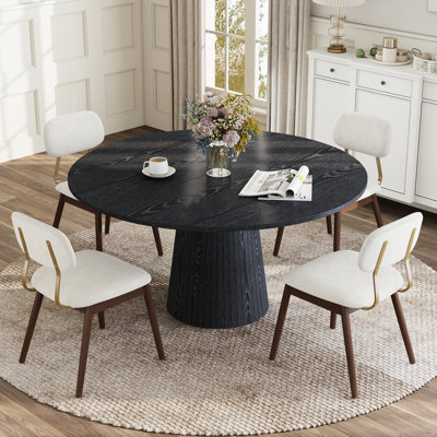Ensemble de table et chaises de salle à manger rondes modernes de 119 cm (47 po) pour 4 à 6 personnes, avec pied central et chaises rembourrées.
