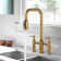 Bridge-Style Kitchen Faucet With Dual Handles And A Pull-Down Spray Head, Designed For Installation On A 3-Hole Kitchen Sink