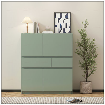 Armoire de rangement verte en bois avec 4 portes et 2 tiroirs, parfaite pour les solutions de rangement organisées et élégantes