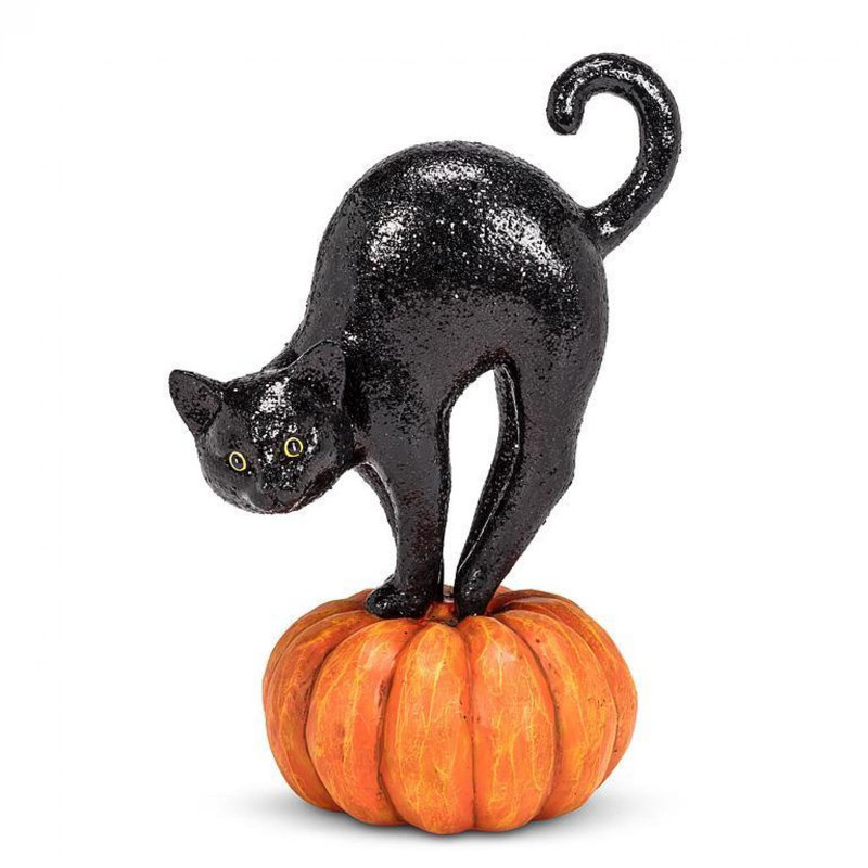 Figurine chat scintillant sur une citrouille