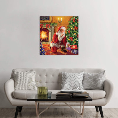 Santa At Tree With Present by Marcello Corti - Wrapped Canvas Print