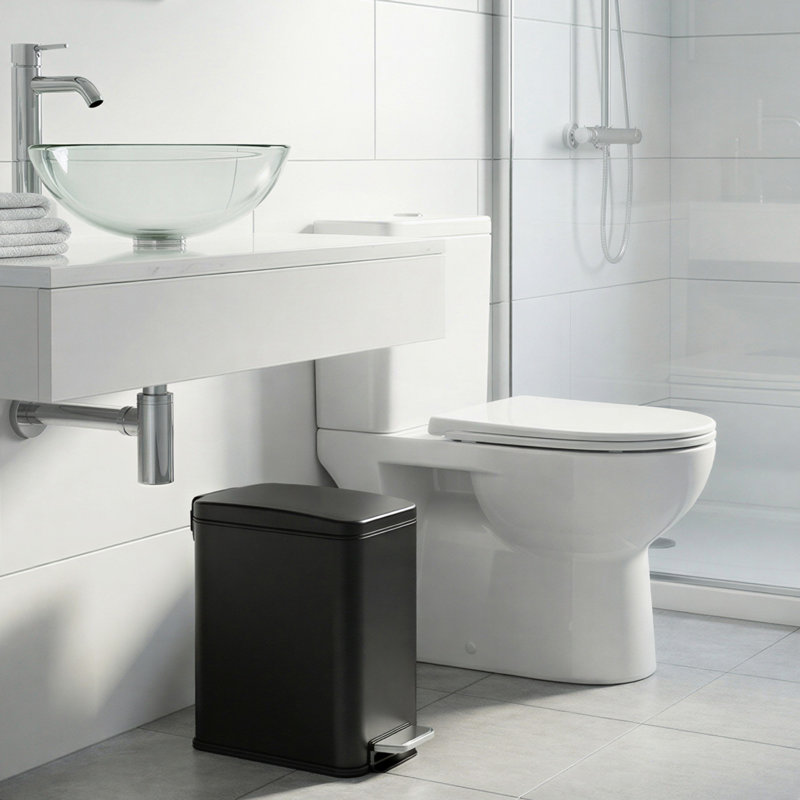 Matte black rectangular step trash can in a modern bathroom.