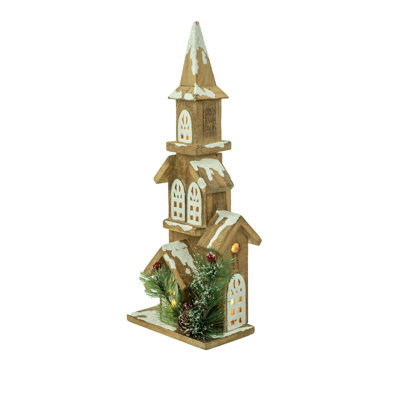 Église éclairée de table brune recouverte de neige