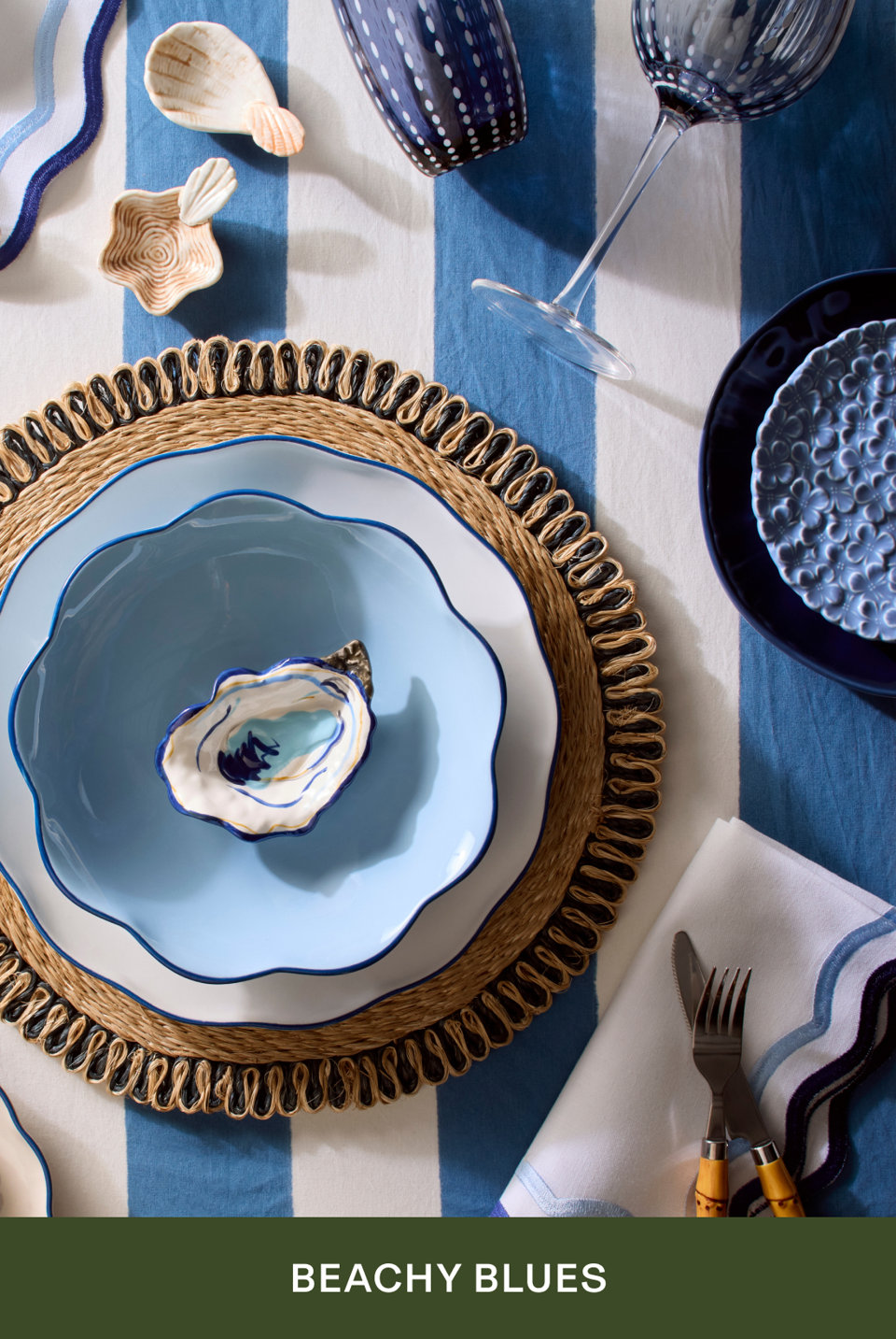 Beachy Blues - coastal table setting with blue and white dinnerware, oyster dishes, and striped tablecloth