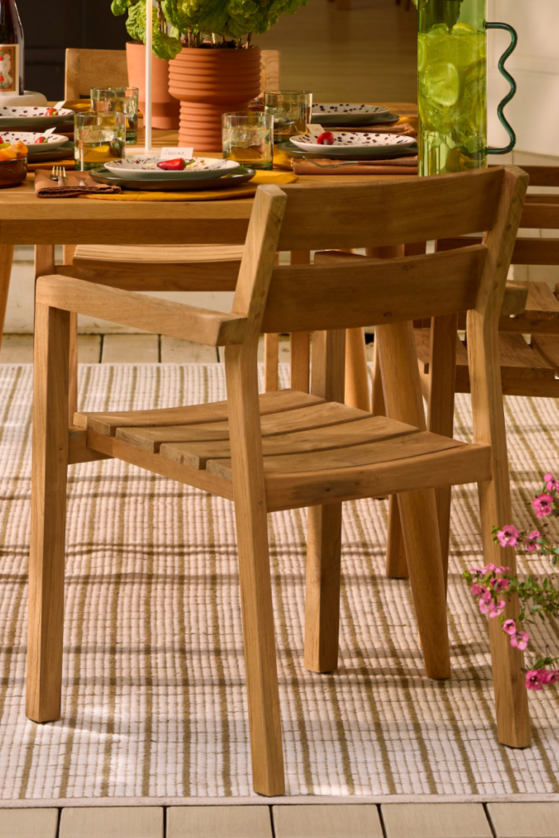Wooden chair at an outdoor dining table.