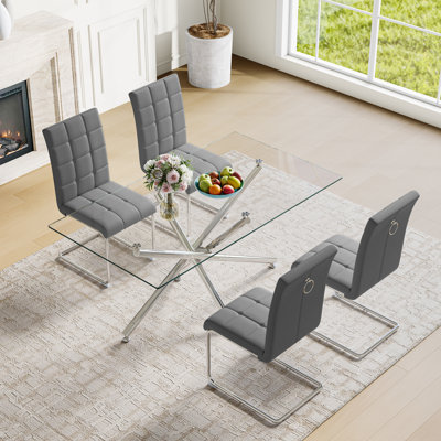 Ensemble de salle à manger moderne 5 pièces - Table rectangulaire en verre avec base en métal et 4 chaises en similicuir