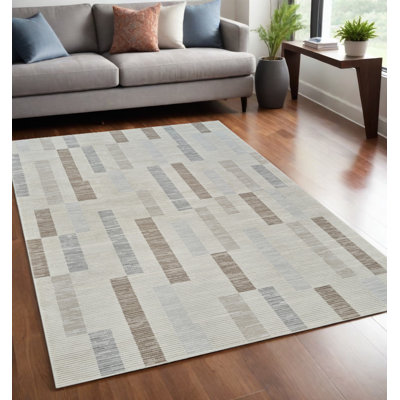 5' X 8' Beige and Brown Abstract Distressed Area Rug