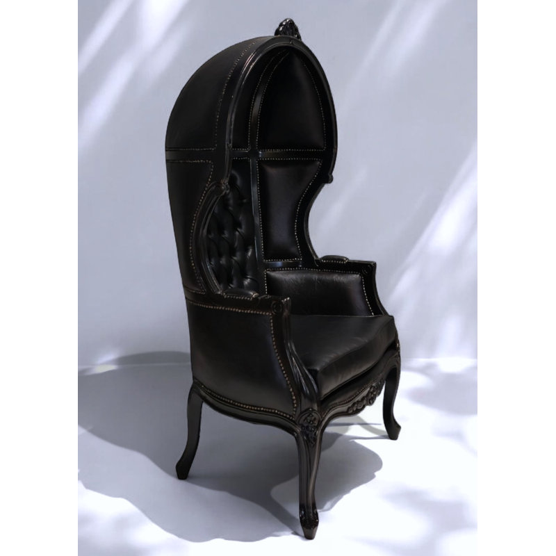 Fauteuil capitonné en similicuir noir capitonné