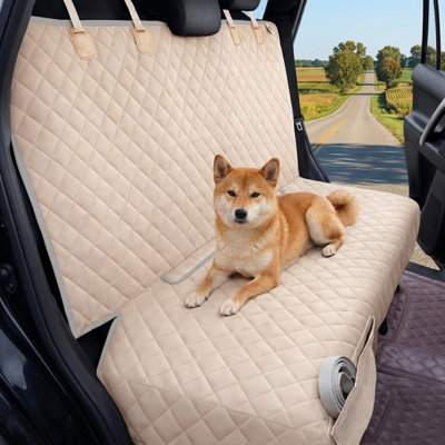 Waterproof rear compartment seat protector for canines featuring slip-resistant properties, rear seat barrier suitable for children, universal sizing compatible with cars, trucks, and sport utility vehicles, colored beige.