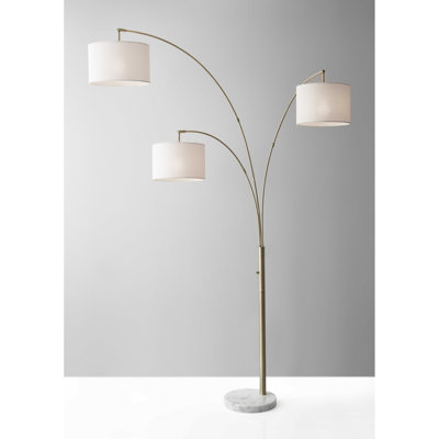 74" Brass Three Light Arc Floor Lamp With Off White Fabric Drum Shade