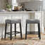 Tabourets de bar sans dossier Oenone, siège de selle rembourré avec garniture cloutée, pieds en bois patiné - ensemble de 2-935972645-935972648-935972649