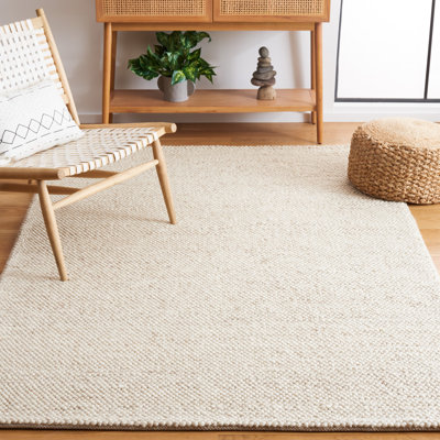 Almus Solid Colour Handmade Tufted Area Rug in Beige/Ivory