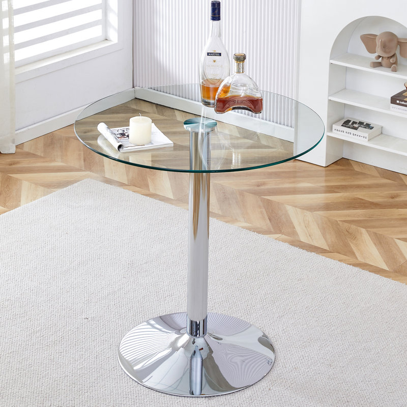 Un plateau de table en verre d'un diamètre de 35 pouces et une table de salle à manger circulaire minimaliste moderne avec des pieds en métal argenté électrolytique.