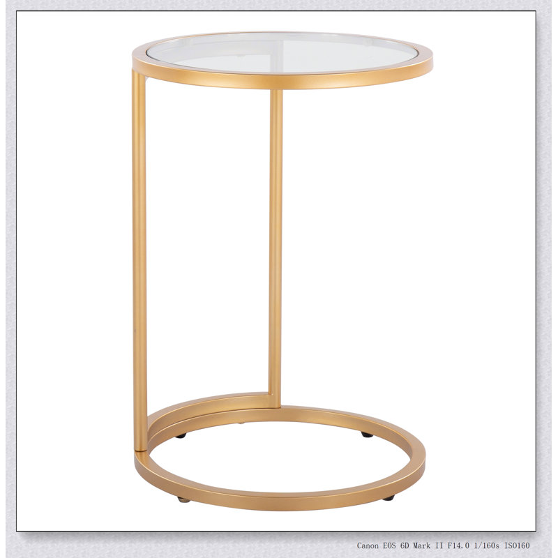 Table de bout ronde Zenn avec structure en métal doré et plateau en verre transparent, parfaite pour les intérieurs modernes et élégants