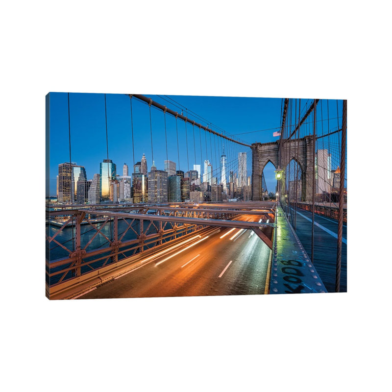 Brooklyn Bridge At Night With Manhattan Skyline In The Background by Jan Becke - Wrapped Canvas Print