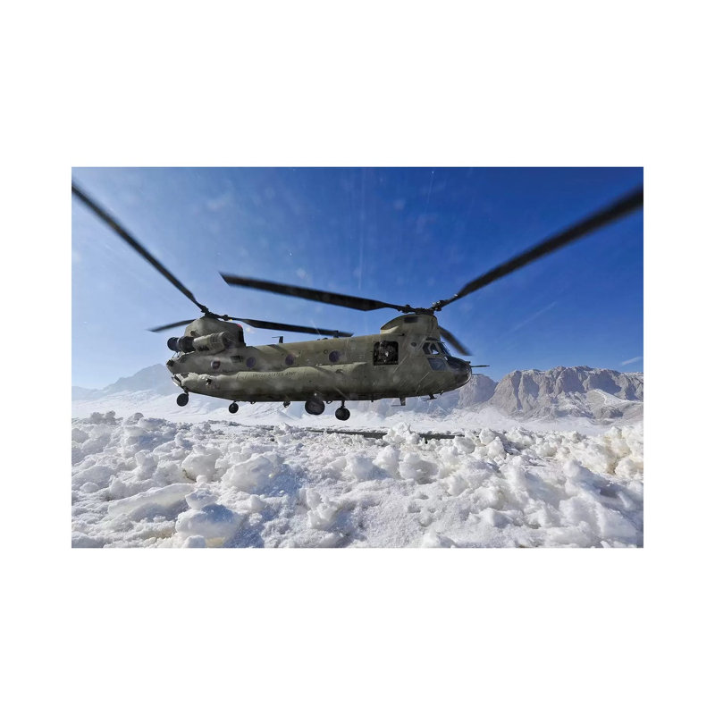 Snow Flies Up As A US Army CH-47 Chinook Helicopter Prepares To Land by Stocktrek Images - Wrapped Canvas Print