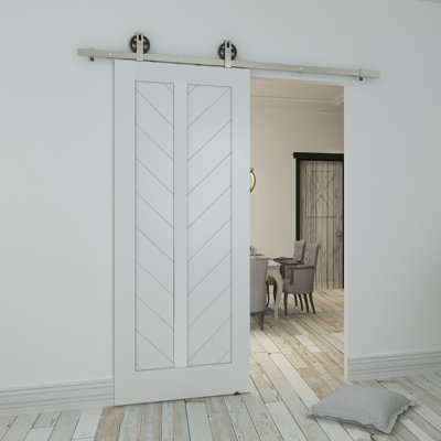 Paneled and Wood Primed Chevron Barn Door without Installation Hardware Kit