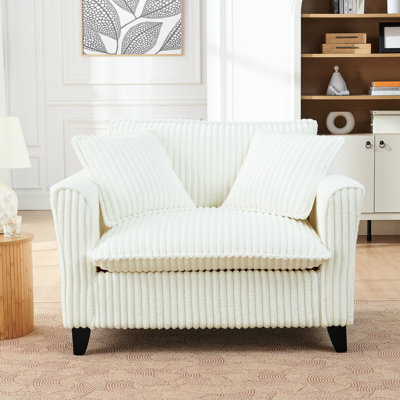 Fauteuil confortable en velours côtelé beige, et pour un moment de détente dans le fauteuil en velours côtelé, coussin résilient, tache de confort