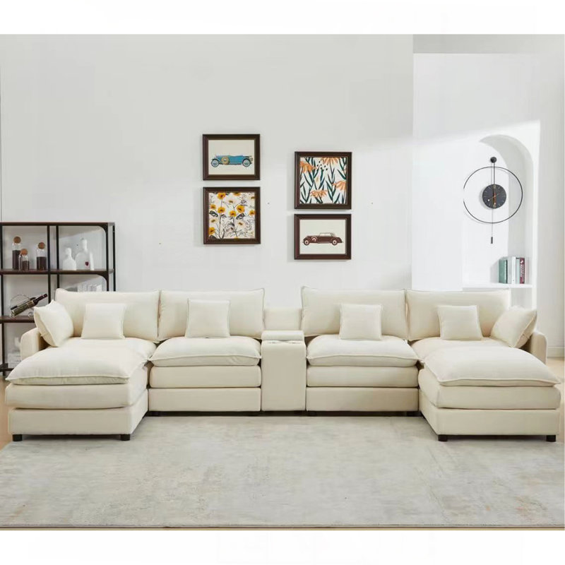 Ensemble de canapé sept pièces, avec une console centrale, une table basse et six coussins, idéal pour les salons spacieux et les salles de réunion.