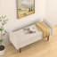 Banc en velours beige avec rangement supplémentaire pour l'organisation du salon