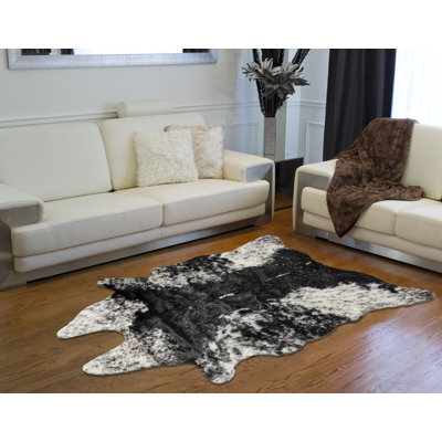 Novelty Loewen Animal Print Faux Sheepskin Area Rug in Black/White
