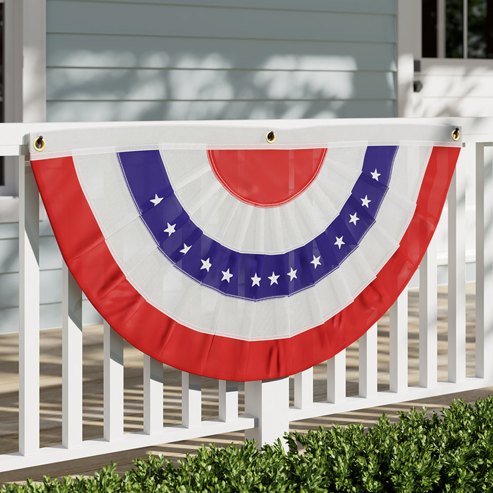 Red, white, and blue patriotic bunting on a white porch railing