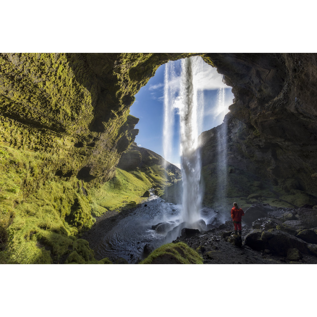 Wanderer am majestätischen Kvernufoss Wasserfall in Island von DieterMeyrl - Kunstdrucke ohne Rahmen auf Leinwand