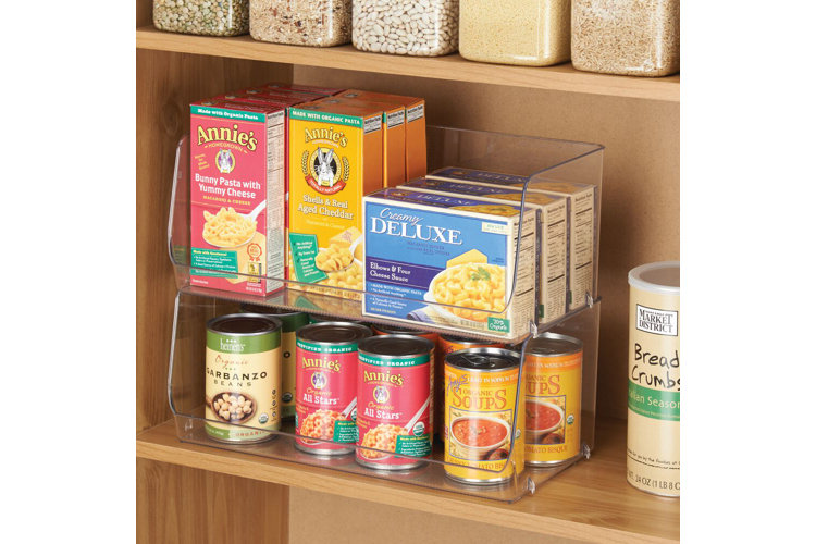Pantry with clear stackable bins used to store dried pasta and canned goods.