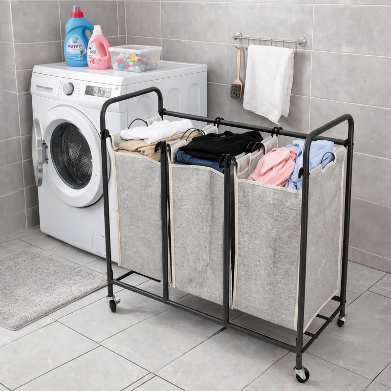 Gray Three-Compartment Metal Laundry Trolley With Locking Wheels And Detachable Fabric Storage Basket With Handle.