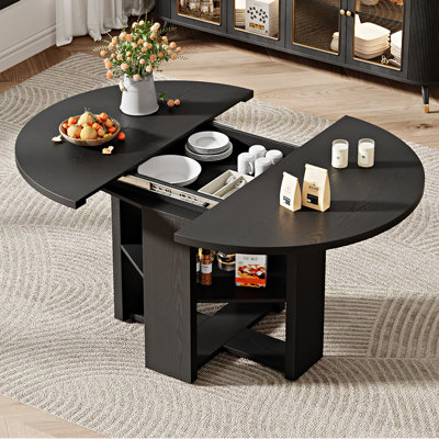 Table de salle à manger extensible ronde à ovale de 109 à 150 cm de large pour 4 à 6 personnes, avec rangement dissimulé et piètement en croix, style ferme moderne.