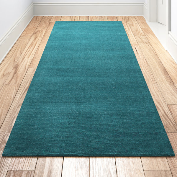 https://assets.wfcdn.com/im/46610842/resize-h600-w600%5Ecompr-r85/2066/206658141/Americus+Handwoven+Wool+Teal+Area+Rug.jpg