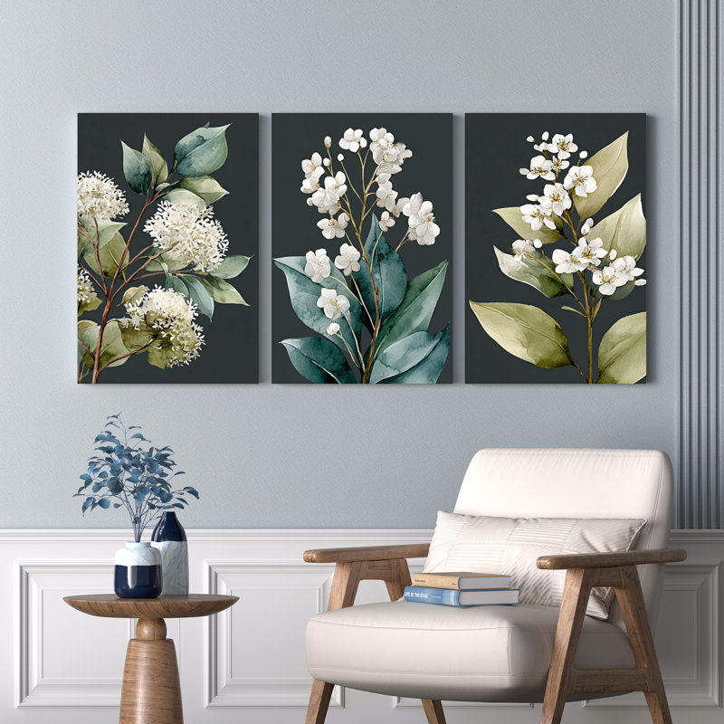 Ensemble de 3 tableaux muraux botaniques sur toile tendue, représentant des fleurs blanches et des feuilles vertes.