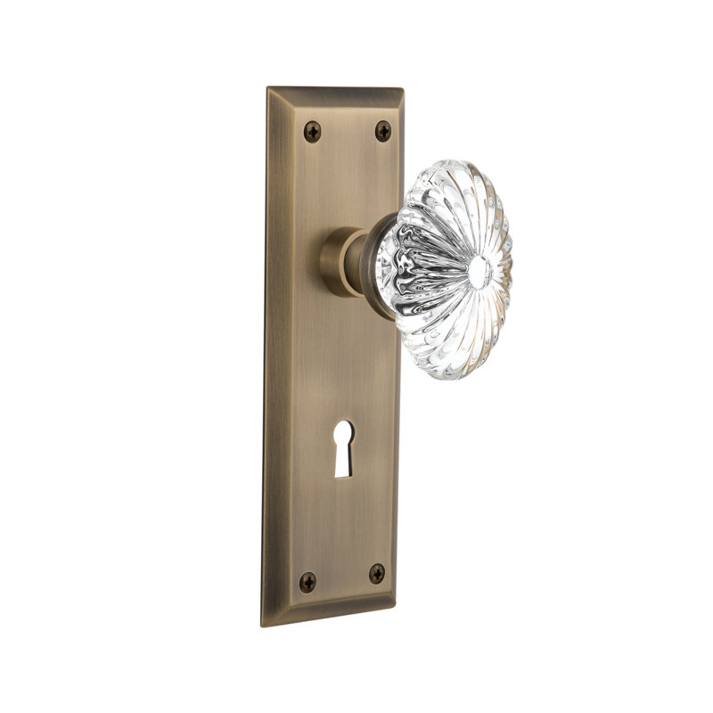New York Plate with Decorative Keyhole and Oval Fluted Crystal Door Knob, Antique Brass
