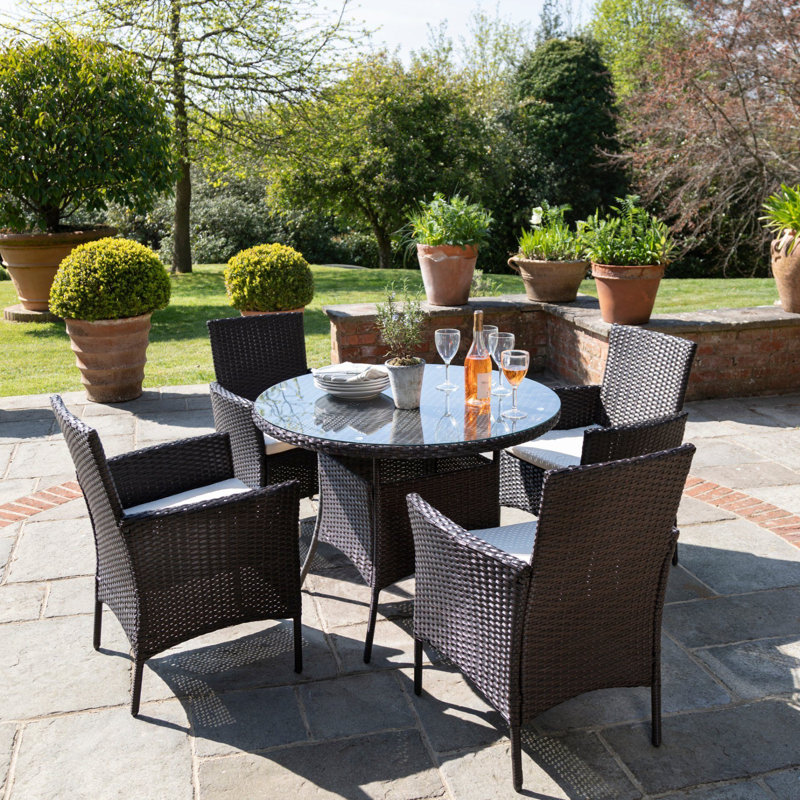 Dubose 4 - Person Wicker Patio Dining Set with Round Table , Cushions Included, Brown, No