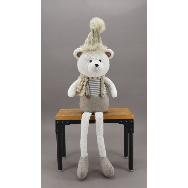 Figurine d'ours assis portant un chapeau