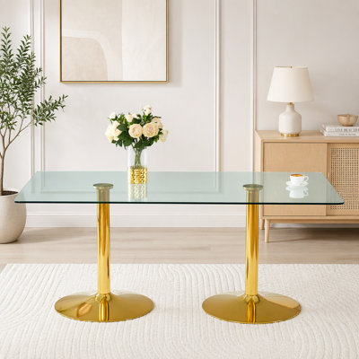 Table de salle à manger ronde moderne et minimaliste avec pieds plaqués or et plateau spacieux en verre trempé, idéale pour des repas élégants et des réceptions conviviales.