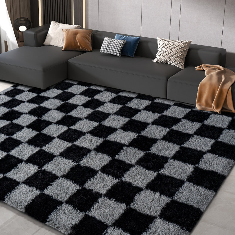 Black and gray checkered area rug with an ultra-soft, non-slip backing, suitable for living rooms, bedrooms, and nurseries.