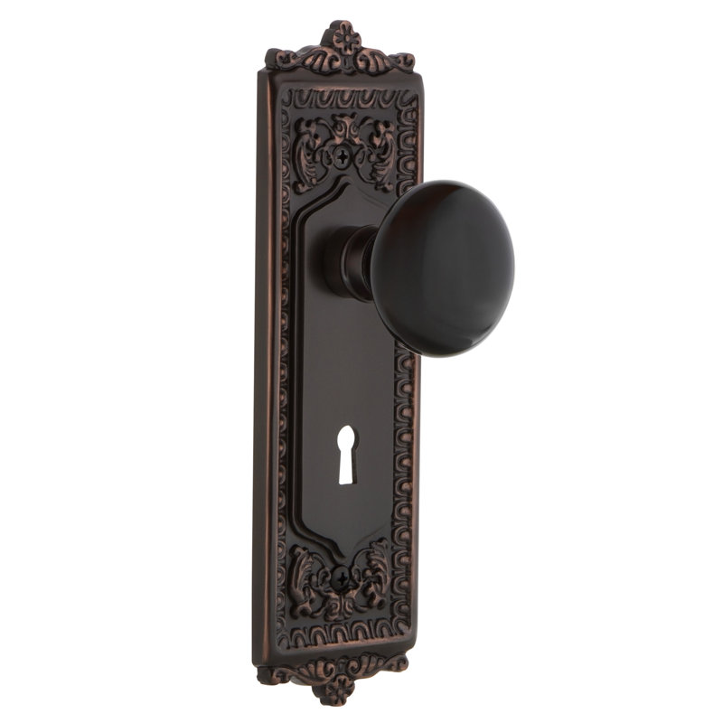 Egg & Dart Plate avec trou de serrure décoratif et bouton de porte en porcelaine noire, 2 3/8 po, Bronze intemporel