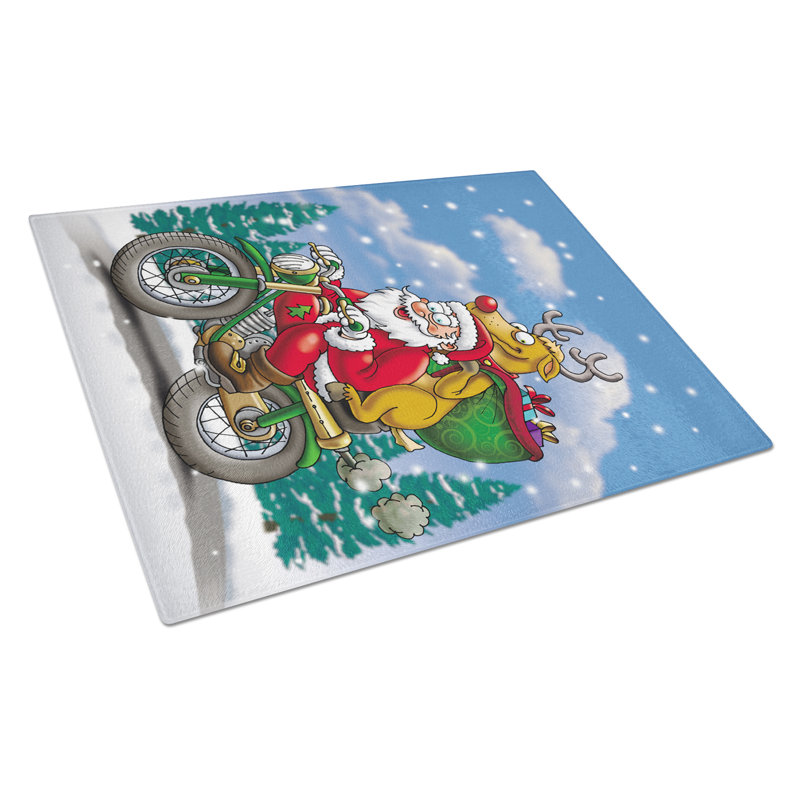 Caroline père noël père noël sur une planche à découper en verre de motocyclette
