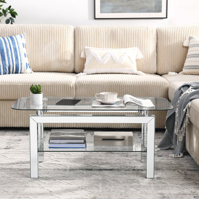 Table basse argentée en verre trempé avec tablette inférieure et pieds en miroir