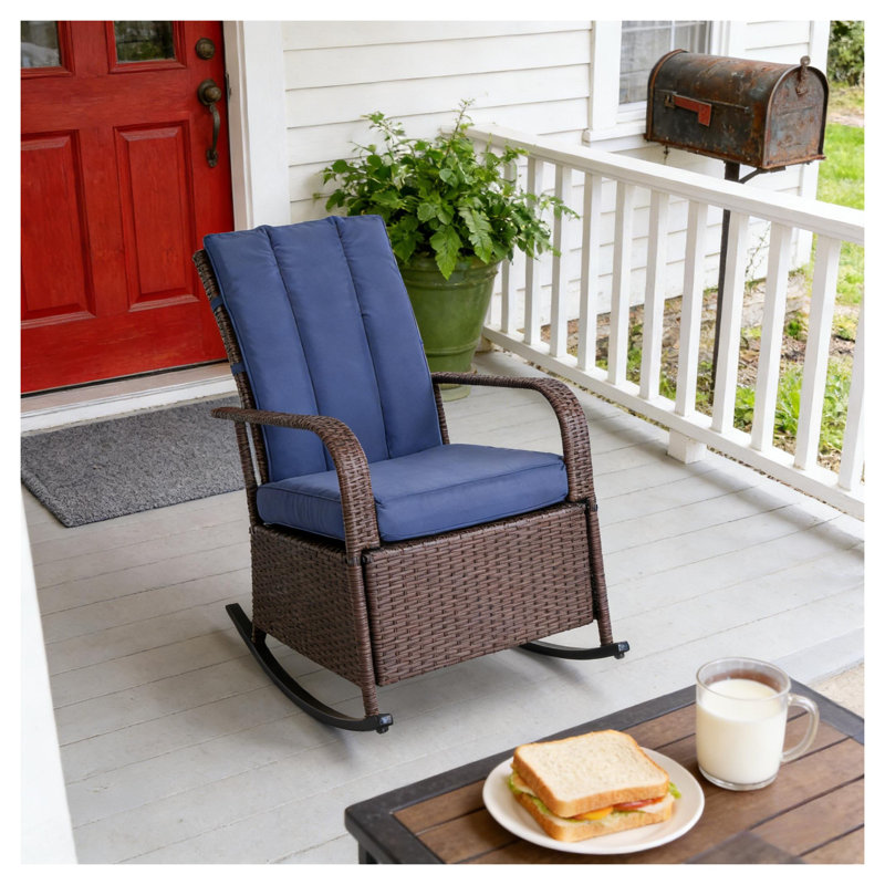 Chaise berçante d'extérieur en osier avec coussin bleu et structure en acier
