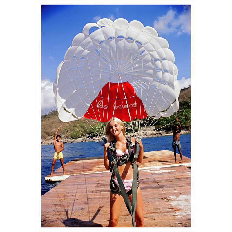 Paragliding In Acapulco Print by Slim Aarons, 48.5" H x 32.5" W x 0.1" D, Unframed