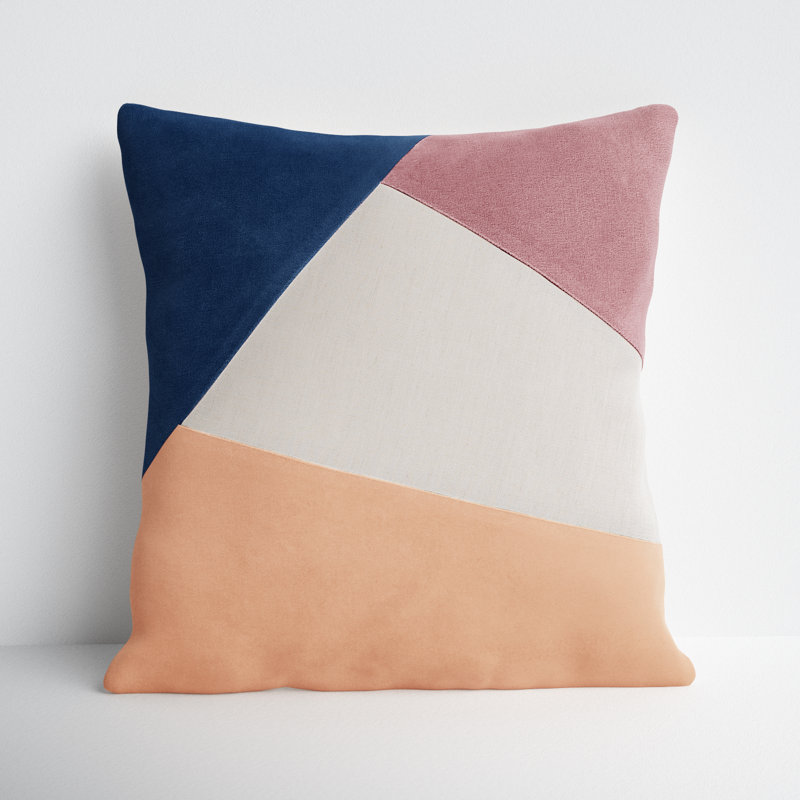 A blue, white, pink, and orange color blocked throw pillow