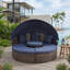 Lit de jour d'extérieur rond en rotin Table basse intégrée Clamshell-126618462
