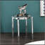 Table d'appoint ronde en chrome brillant avec pattes extérieures effilées